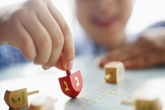 child playing with dreidel